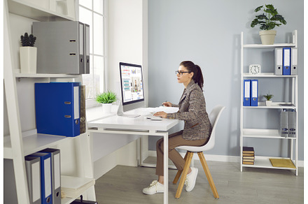 Young woman working on a desktop, a Person Photo by StudioRomantic