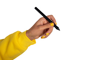 Close-up of a hand in a yellow sleeve holding a black stylus pen, a Technology Photo by Ales Munt