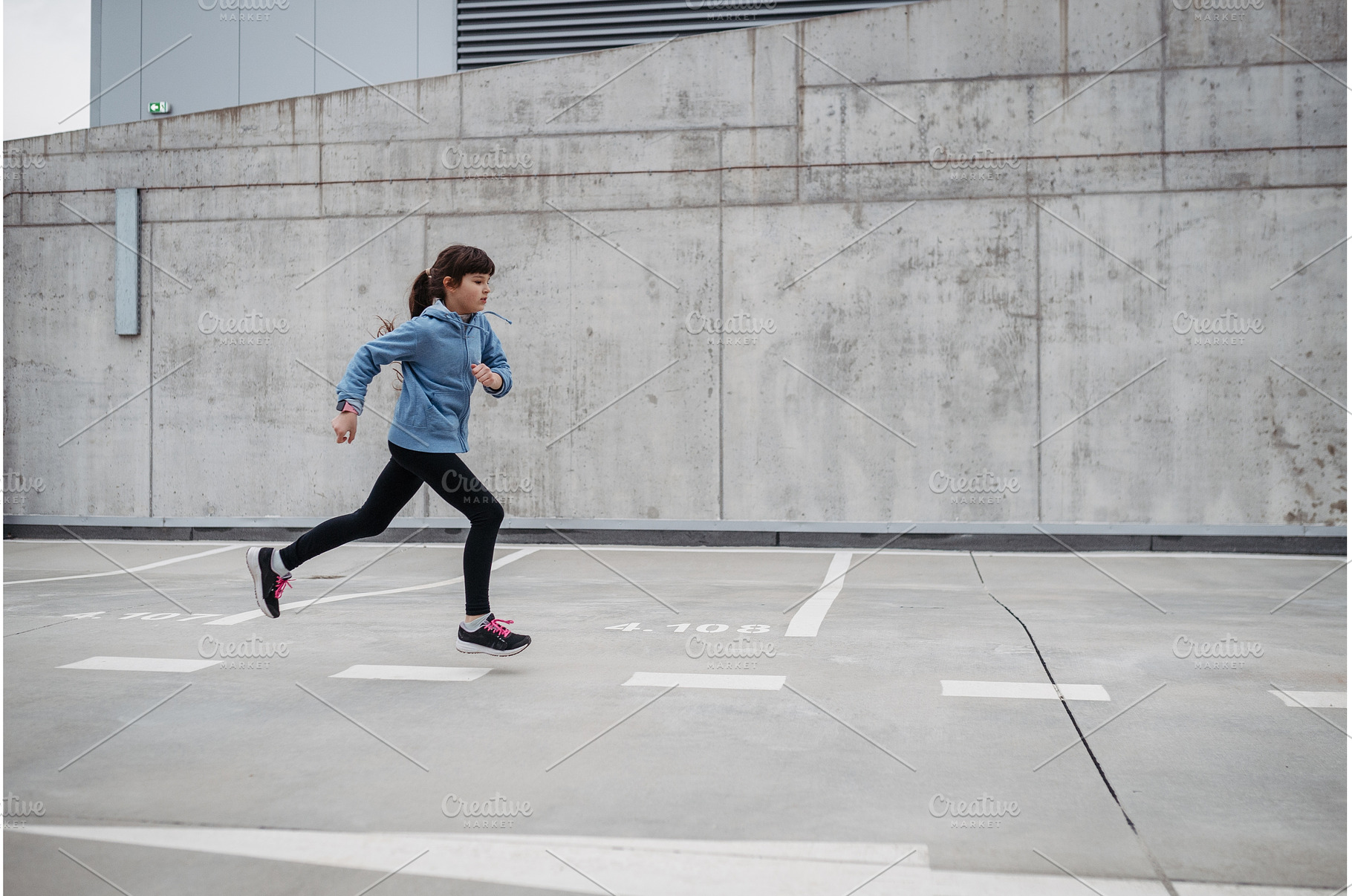 Girl in city running, doing sport, a School & Education Photo by HalfPoint