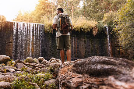 Explorer looking at waterfall in for, a Person Photo by Perpis