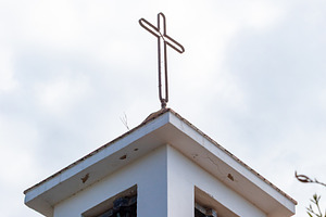 Simple white bell tower with metal cross and two bells standing out against clo, a Photo by Antonio Gravante Market
