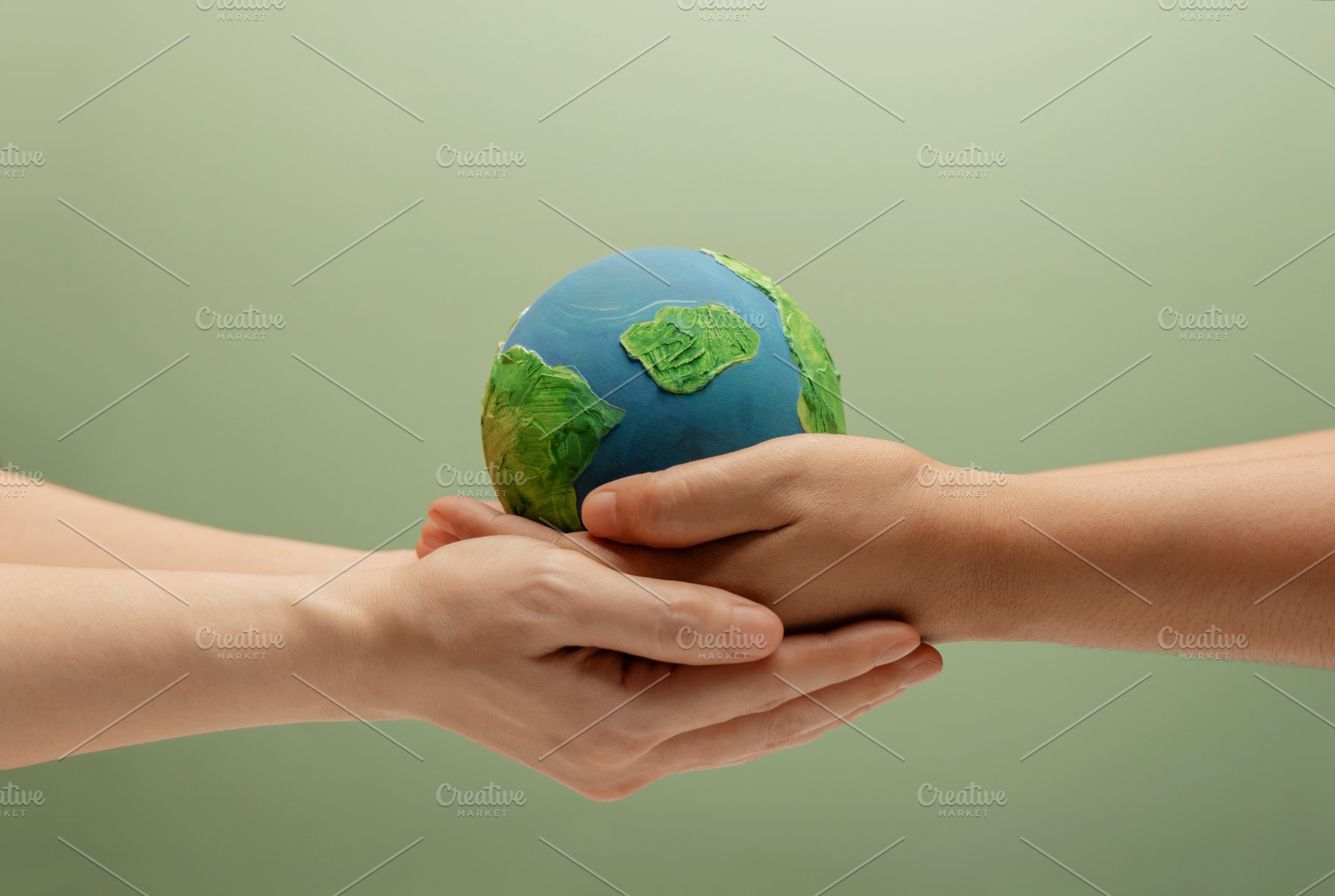 Two people holding Globe together. Environmental awareness, sust, a Photo by salmon.black