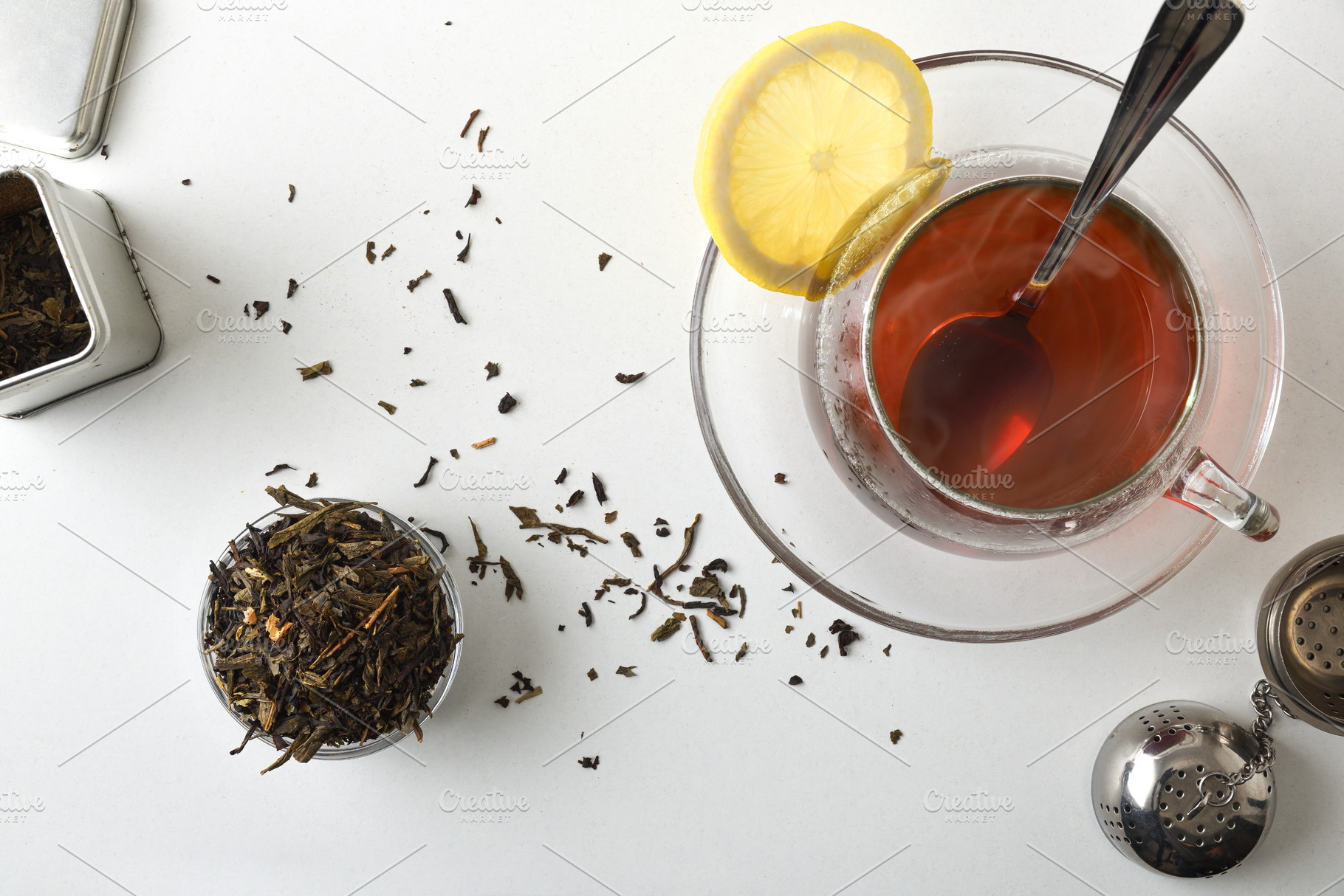 Glass teacup on a white bench with containers with tea, a Food & Drink Photo by Davizro's Market