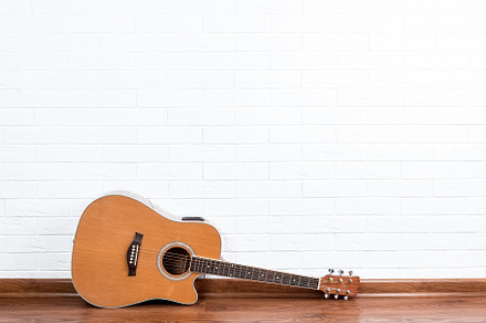 Guitar on a brick wall background., an Arts & Entertainment Photo by AlexBush