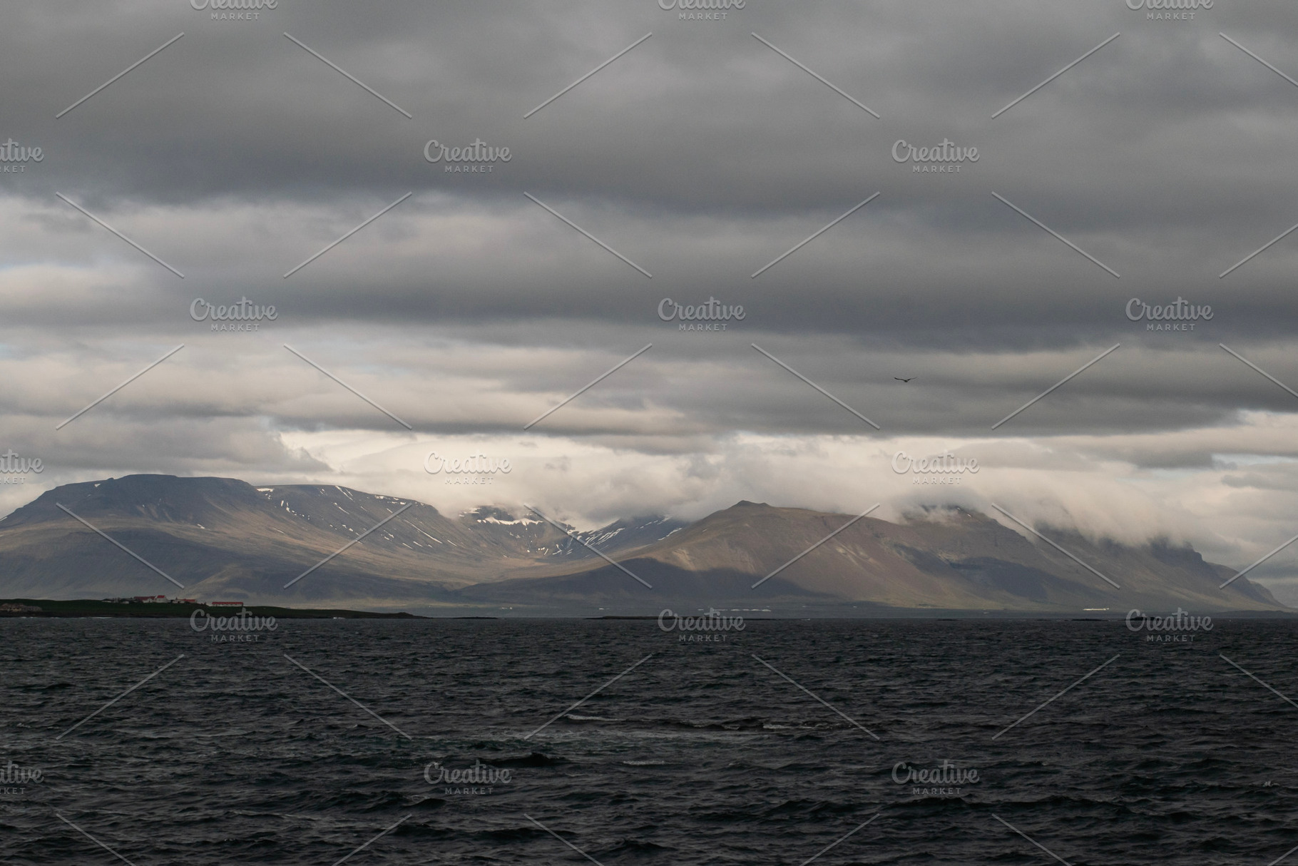 Majestic view of mountains and ocean near Akranes, Iceland under cloudy skies, a Photo by AS photostudio