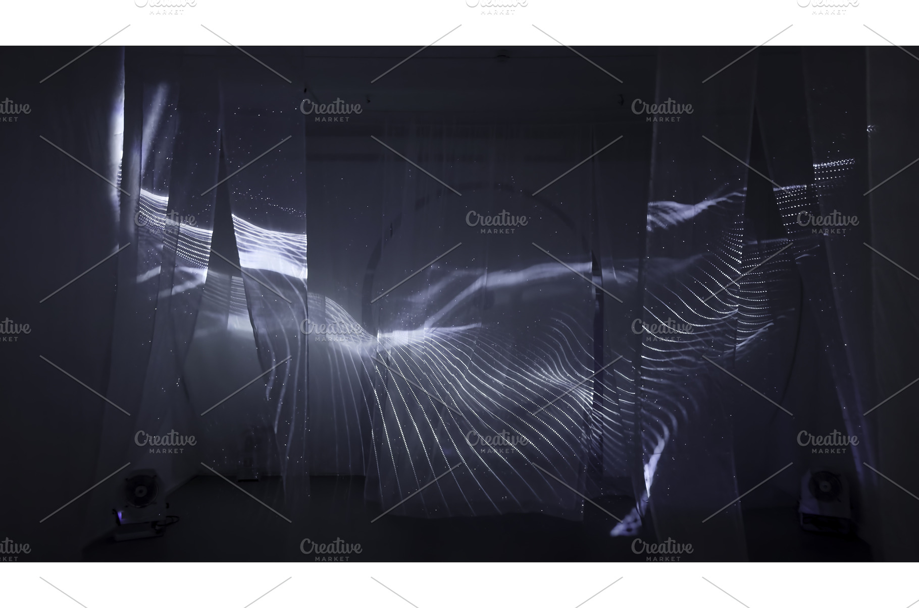 Light patterns projected on fabric, a Background Photo by Media Whale Stock