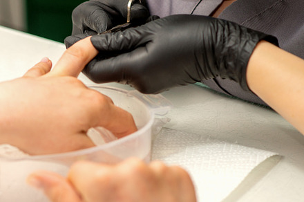 Manicure painting process. Manicure master paint the nails with transparent var, a Beauty & Fashion Photo by okskukuruza