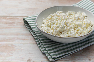 Fresh natural cottage cheese on wooden background with napkin, a Food & Drink Photo by Olena Rudo