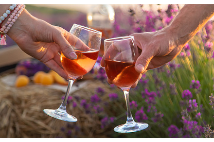 Wine in glasses is held by a woman, a Person Photo by yanadjana