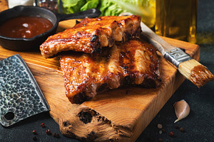 Spicy hot grilled spare ribs from a summer BBQ served with a hot chili pepper a, a Food & Drink Photo by Budarinphoto