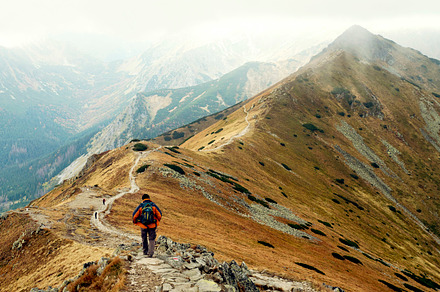 Backpacker in the mountains containing mountain, autumn, and hiking