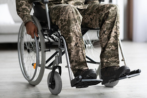 Legs of disabled african american military man in wheelchair, a Photo by Prostock-Studio