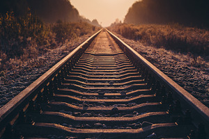 Railroad at sunrise featuring sunrise, sun, and sky