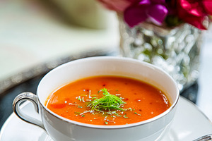 Creamy gourmet tomato soup in an elegant white porcelain cup, ga, a Photo by Studio ANNA