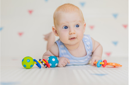 Adorable baby playing with colorful