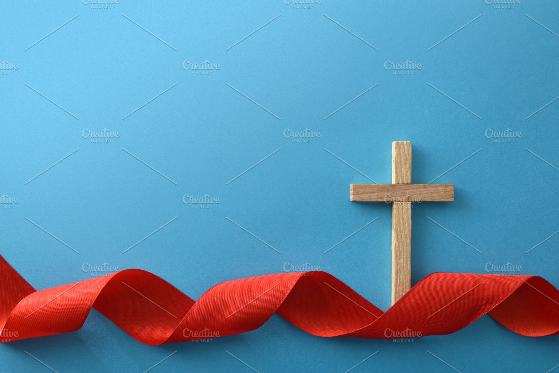 Wooden Cross with Red Ribbon on Blue Background, a Holiday Photo by Davizro's Market