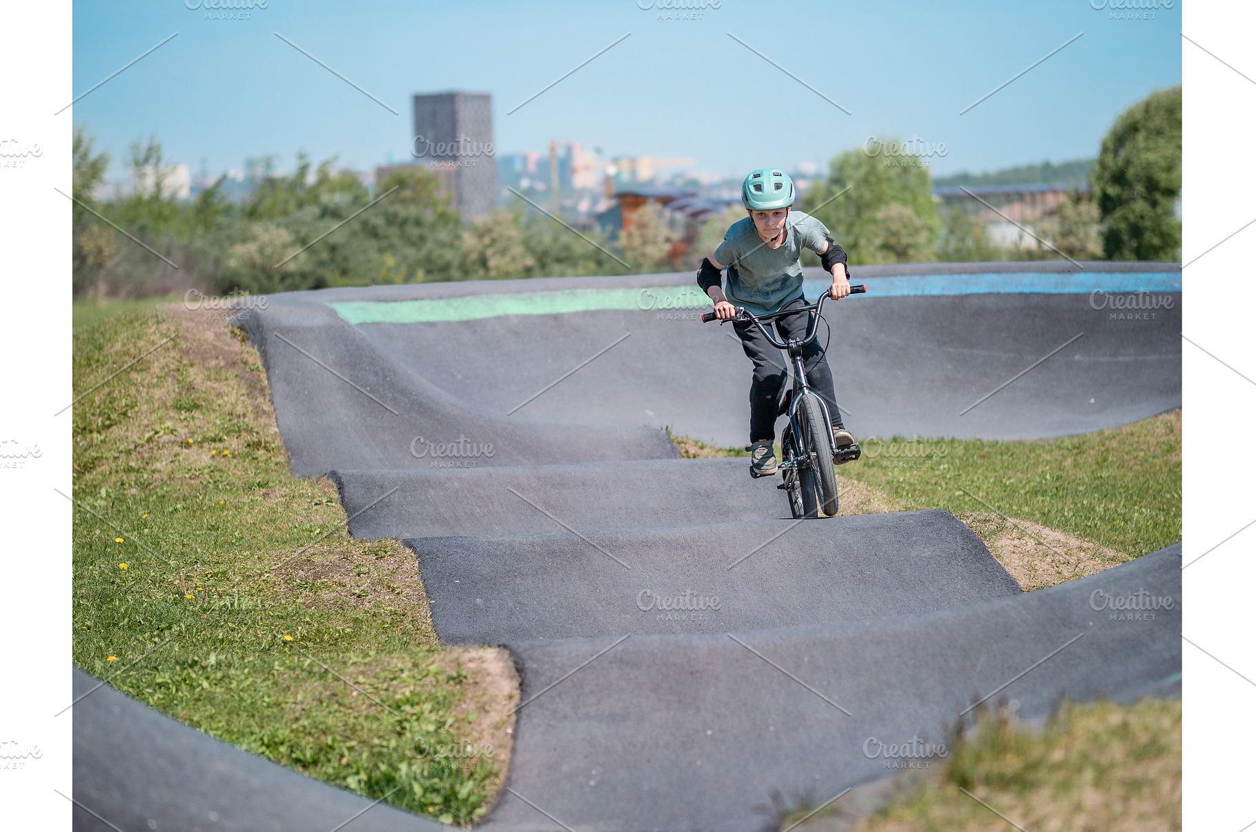 Pump track. Child on bmx bike rides, a Sports & Recreation Photo by Fascinadora