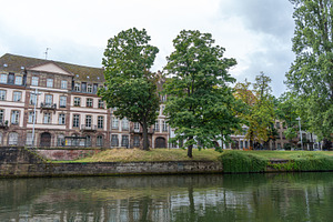 Riverside buildings and trees along the Ill river Strasbourg, Fr, an Architecture Photo by GoodGoods