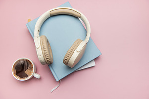 Wireless headphones resting on books with coffee nearby, embraci, a Technology Photo by Olena Rudo