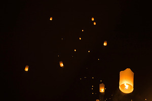 Sky lanterns glowing in night featuring lanterns, night, and sky