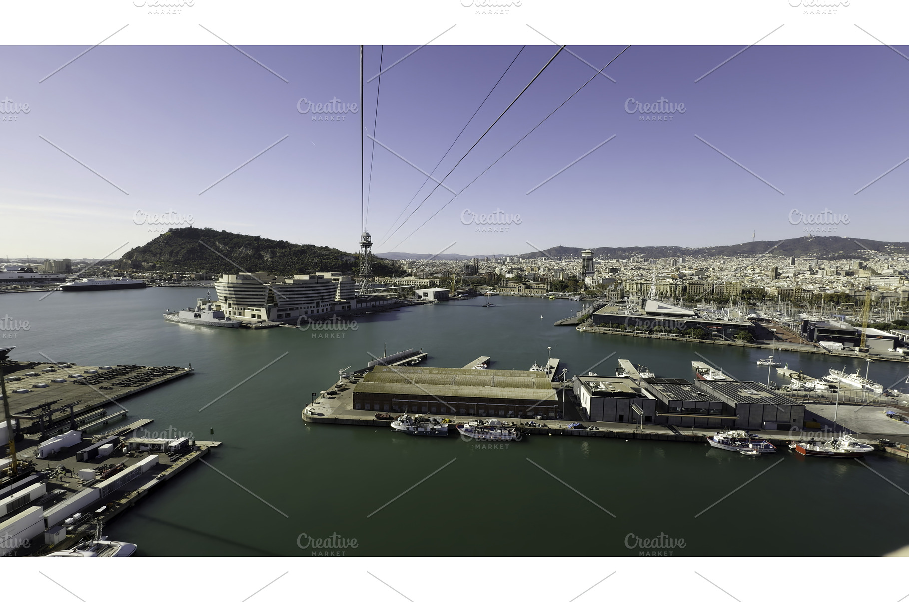 Cable car moving over barcelona port, a Transportation Photo by Media Whale Stock