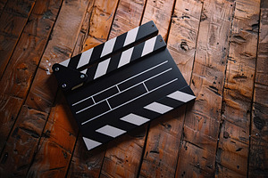 Clapper board on wooden background, a Technology Photo by AlyaAnd