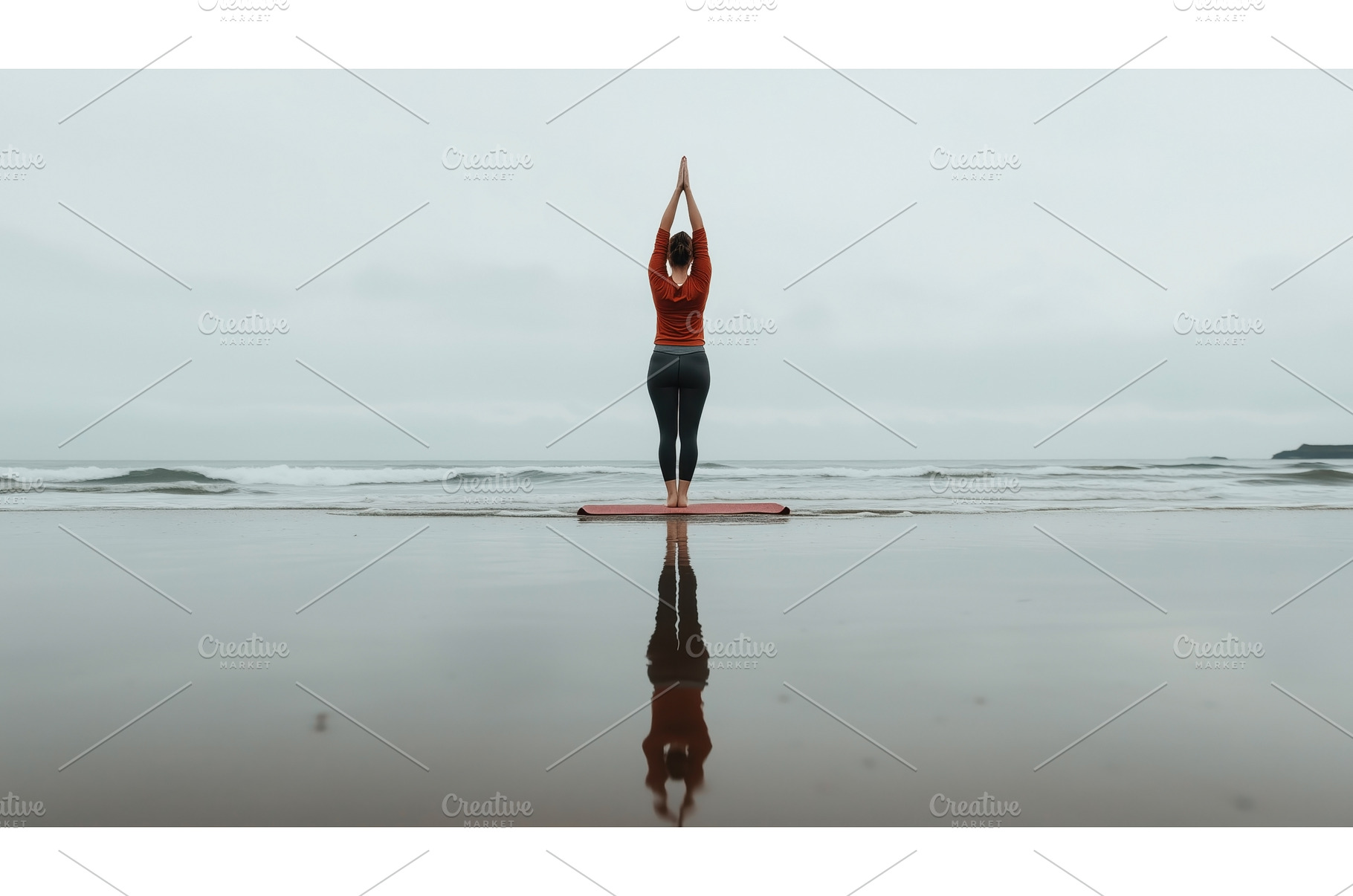 A woman practices yoga on a beach, a Sports & Recreation Photo by Sergey Kotenev