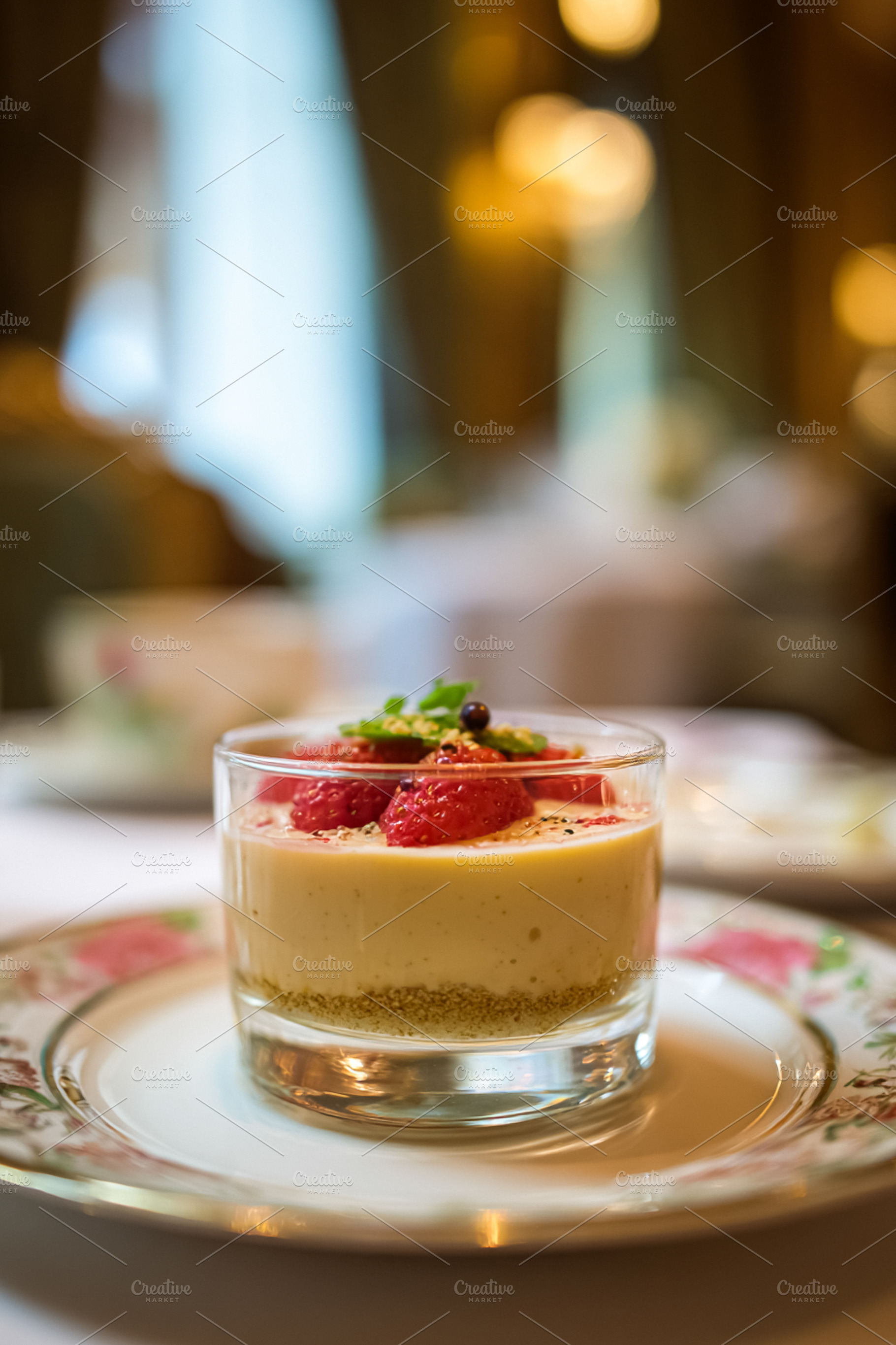 Strawberry cheesecake mousse served in a glass on a decorative p, a Food & Drink Photo by Studio ANNA