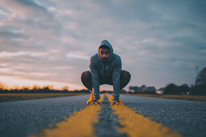 Runner prepares on empty road, a Photo by Beautiful things