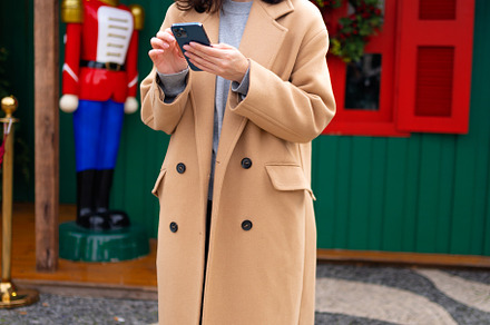 Woman in glasses using mobile phone at day in the city, a Person Photo by andreonegin market