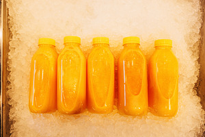 Five bottles with orange juice, a Food & Drink Photo by Artem Varnitsin