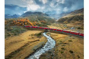Aerial view of red train, river, a Transportation Photo by den-belitsky