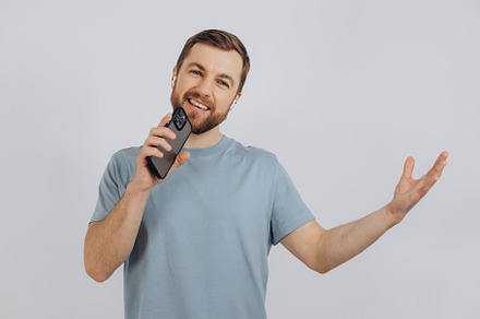 Happy bearded man dancing with earphones, listening music in hea, a Technology Photo by Cherkas Photography