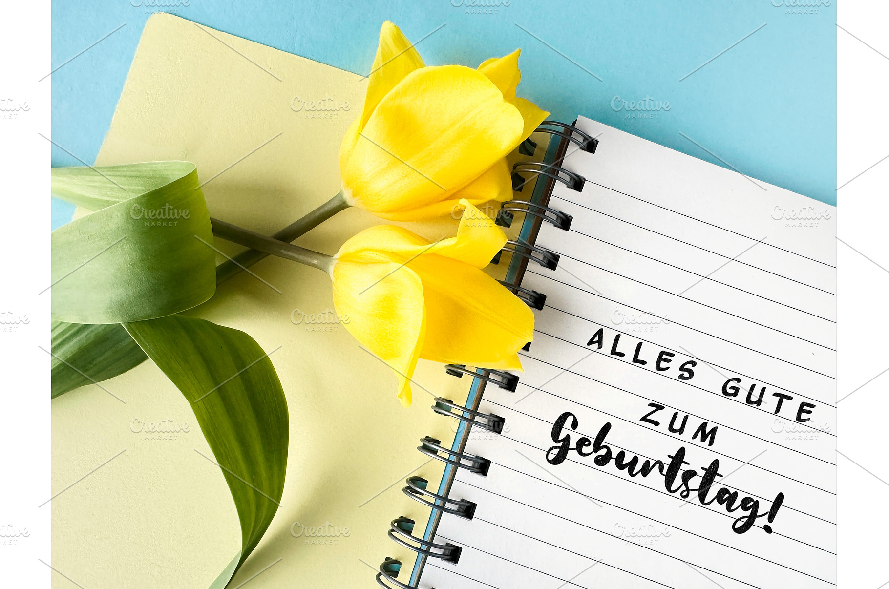 Yellow tulips on a notebook with, a Photo by tilialucida