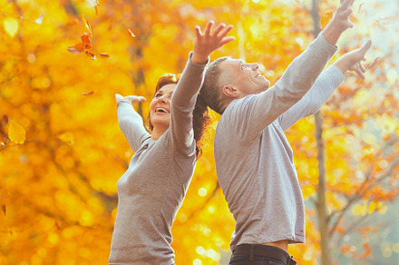 smiling modern couple in park rejoicing, a Person Photo by Alliance Images