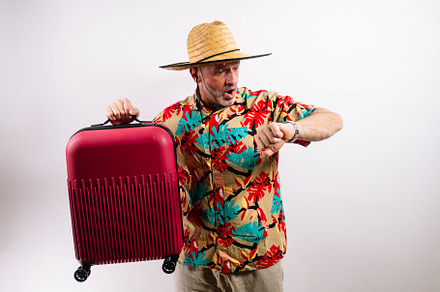 Man ready for vacation with red suitcase