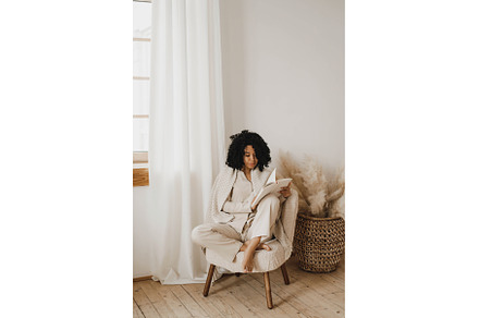 Young African American woman sitting, a Person Photo by Aliona Serzhanova