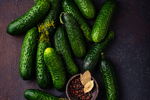 Raw cucumber on dark background, a Food & Drink Photo by Yulia Furman