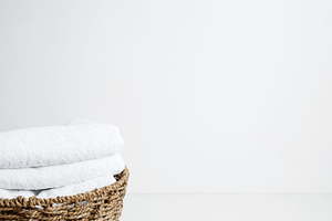 Household cleaning and hygiene concept packaging. Basket filled with clean whit, a Photo by matucha