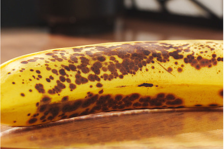 A ripe banana with dark brown spots