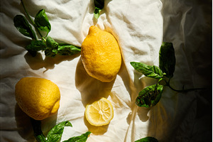 Bright yellow lemons and fresh basil, a Food & Drink Photo by IlliaBondarPhotography