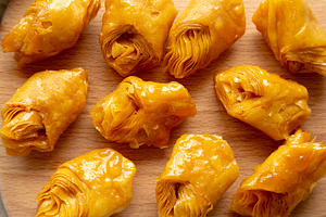 Sweet Homemade Turkish Baklava with Honey on a Wooden Board, top, a Food & Drink Photo by LiudmylaChuhunova
