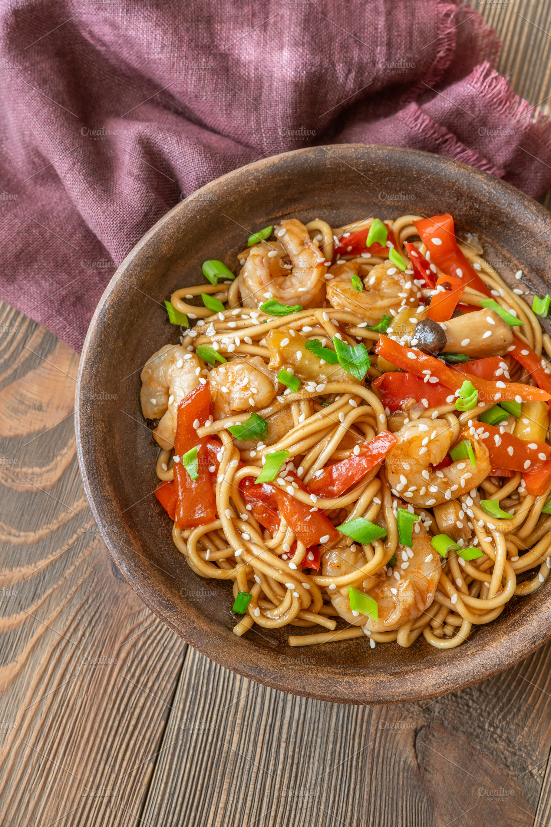 Close up Asian udon noodles with shrimp mushrooms sesame glossy, a Food & Drink Photo by Alexander Prokopenko