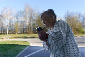 Female patient in hospital gown, a Health & Medical Photo by HalfPoint