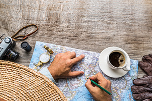 Man looking for new travel destinations on the world map., a Holiday Photo by Volff
