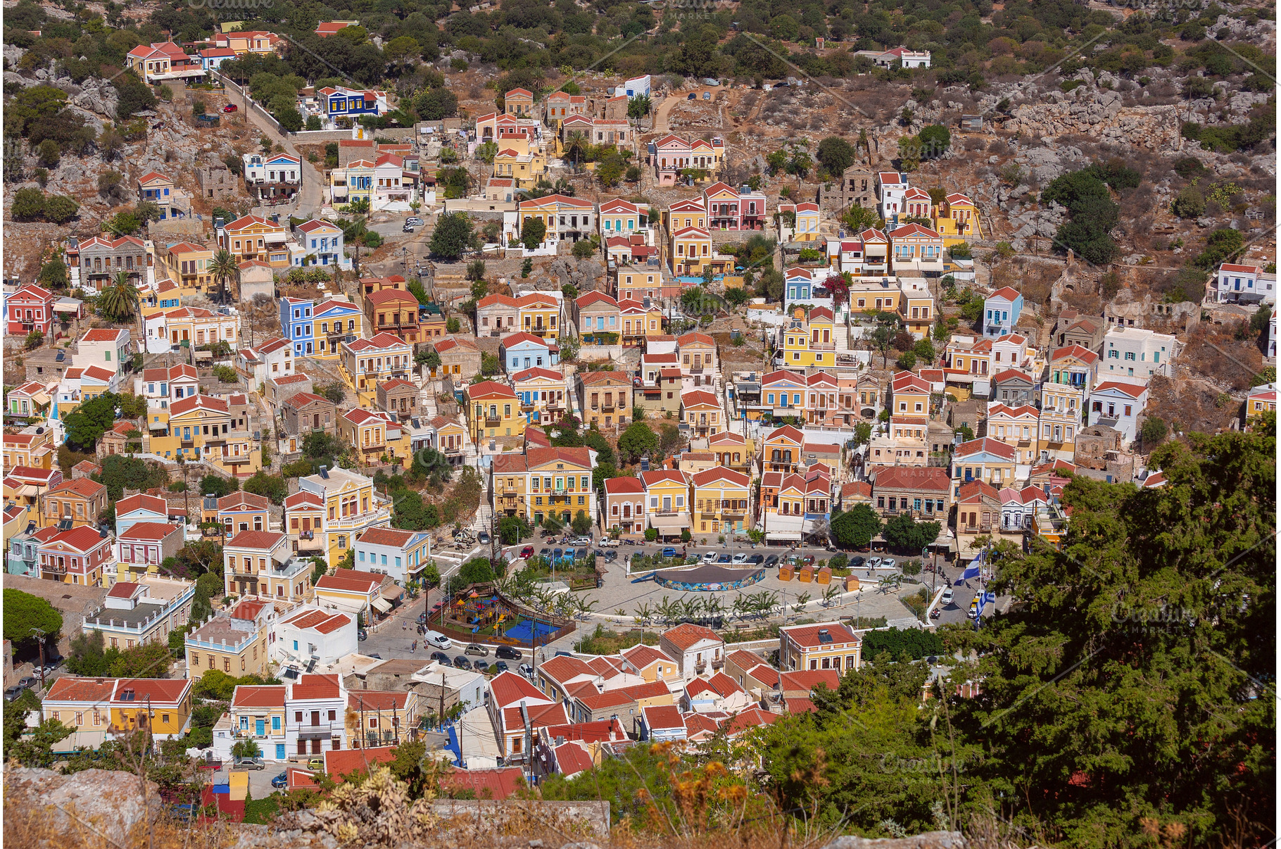 Colorful hillside houses in Symi, an Architecture Photo by kavalenkava