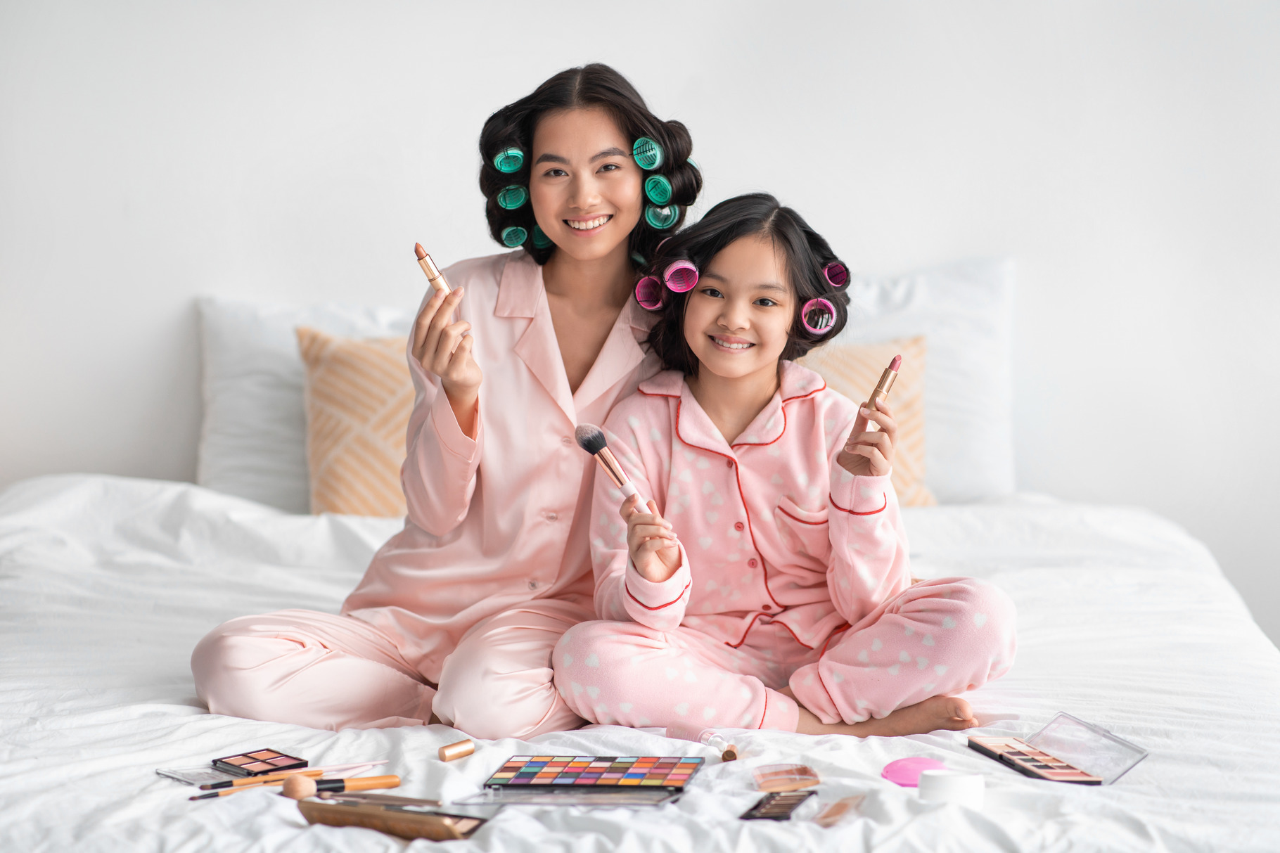 Happy millennial japanese female and adolescent girl with curlers hold ...
