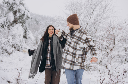 A young happy and loving couple walking in a snowy forest in the, a Person Photo by Cherkas Photography