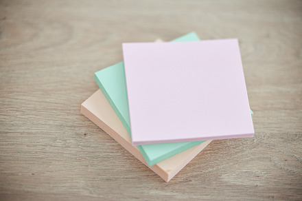 Top view, wood and sticky notes for brainstorming, ideas and planning with communication, schedule and paper. Mockup table and post it for messages, updates and motivation for goals, target and color, a Photo by Peopleimages.com