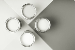 White paint cans on a gray geometric, a Background Photo by Anna Efetova
